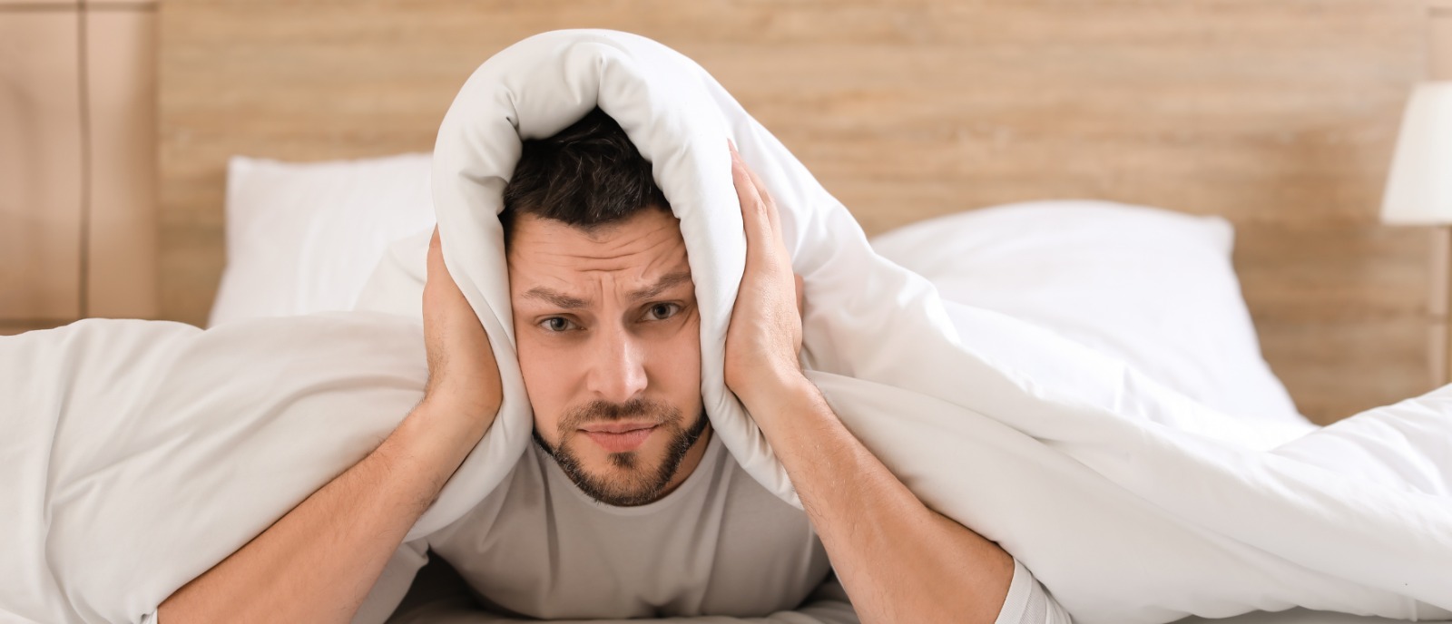 Elderly person experiencing tinnitus and hearing challenges – Common complaints among older adults